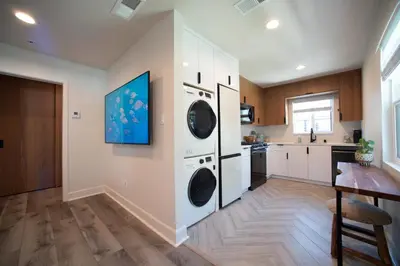 a kitchen with two washer and dryer at Modern 1 BR Cottage Steps 2Beach in San Diego