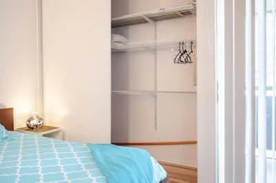 a bedroom with a blue bed and a closet at Studio Apartment with Pool in the Heart of MissionValley in San Diego