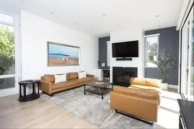 a living room with two couches and a flat screen tv at 4BR Luxury Del Mar Beach House with Ocean Views in San Diego
