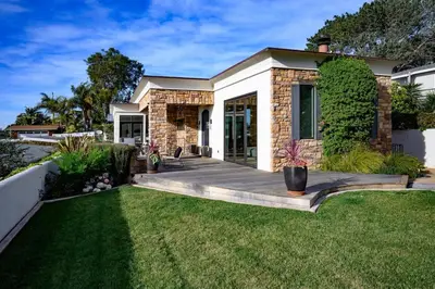 a house with a wooden deck in the yard at 4BR Luxury Del Mar Beach House with Ocean Views in San Diego