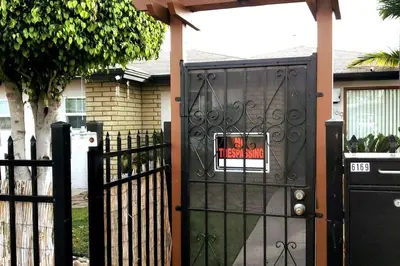 a gate with a sign on it in front of a house at SanDiego Insider's Coastal Bliss and Urban Wonders in San Diego