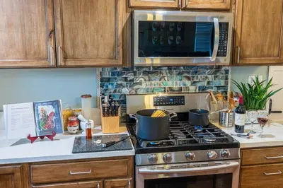 a kitchen with a stove and a microwave at SanDiego Insider's Coastal Bliss and Urban Wonders in San Diego