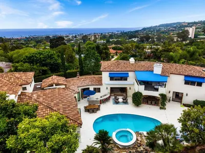 an aerial view of a house with a swimming pool at Grand Mediterranean Villa in La Jolla Hillside in San Diego