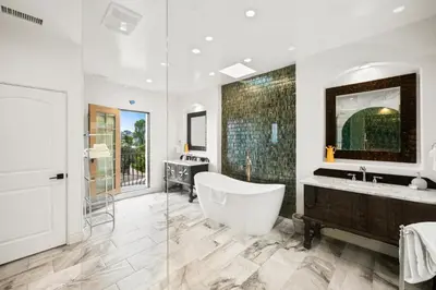 a bathroom with a large tub and a sink at Grand Mediterranean Villa in La Jolla Hillside in San Diego