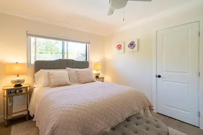 a bedroom with a large bed and a window at Designer Family Home with Resort-Style Oasis in San Diego