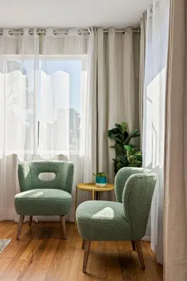 two chairs and a table in front of a window at Beach Abode Walk to the Ocean in San Diego