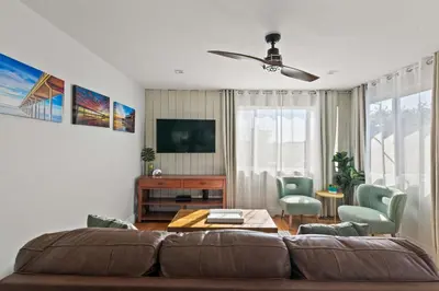 a living room with a couch and a table at Beach Abode Walk to the Ocean in San Diego