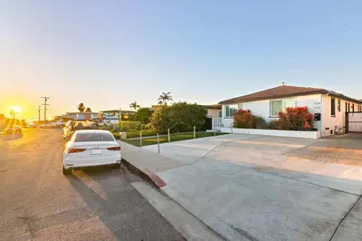 a car parked in a parking lot next to a house at Beach Abode Walk to the Ocean in San Diego