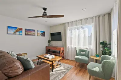 a living room with a couch and chairs and a television at Beach Abode Walk to the Ocean in San Diego