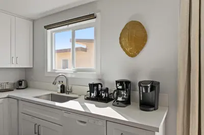 a white kitchen with a sink and a window at Pacific Beach Gem Walk to Law Street Beach in San Diego