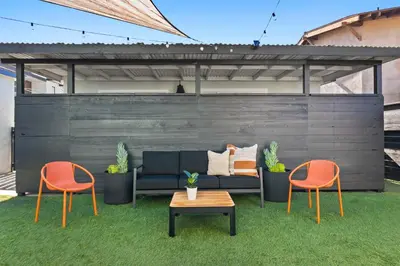 a patio with a couch and two chairs and a table at Pacific Beach Gem Walk to Law Street Beach in San Diego
