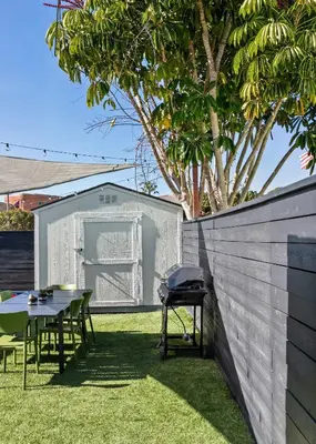 a backyard with a grill and tables and a fence at Pacific Beach Gem Walk to Law Street Beach in San Diego