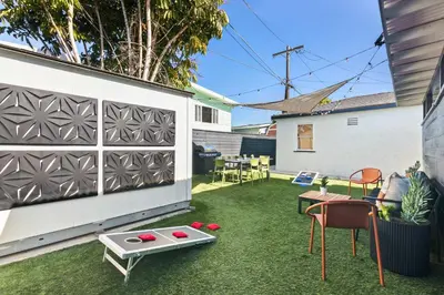 a backyard with a table and chairs on the grass at Pacific Beach Gem Walk to Law Street Beach in San Diego