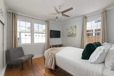 a bedroom with a white bed and a ceiling fan at Pacific Beach Gem Walk to Law Street Beach in San Diego