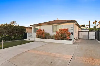 a white house with a fence and a driveway at Pacific Beach Studio Short Walk to Ocean in San Diego