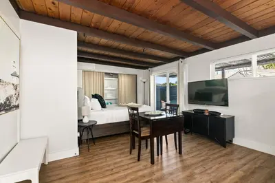 a bedroom with a bed and a desk and a television at Pacific Beach Studio Short Walk to Ocean in San Diego