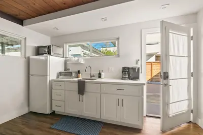 a kitchen with a sink and a refrigerator at Pacific Beach Studio Short Walk to Ocean in San Diego