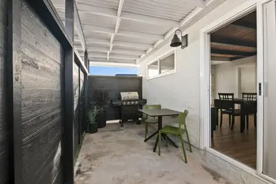 a small patio with a table and a desk at Pacific Beach Studio Short Walk to Ocean in San Diego