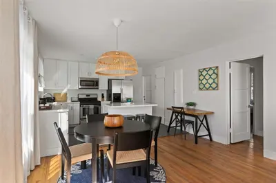 a kitchen and dining room with a table and chairs at 6 Bedroom Family Getaway Walk to Law Street Beach in San Diego