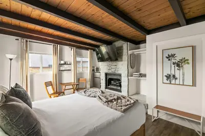 a bedroom with a large bed and a fireplace at 6 Bedroom Family Getaway Walk to Law Street Beach in San Diego