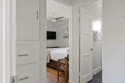 a bedroom with white walls and a bed with a ceiling at 6 Bedroom Family Getaway Walk to Law Street Beach in San Diego
