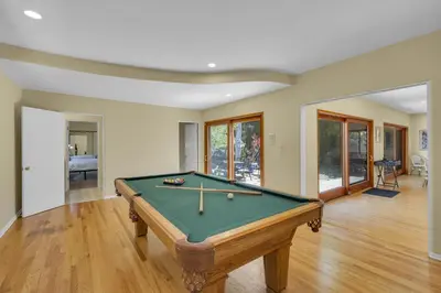 a living room with a pool table in it at Pacific Views Retreat - Rooftop Deck, Game Room, Fire Pit & Cozy Backyard! in San Diego