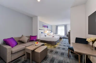 a hotel room with a couch and a bed at Holiday Inn Express & Suites San Diego - Mission Valley by IHG in San Diego