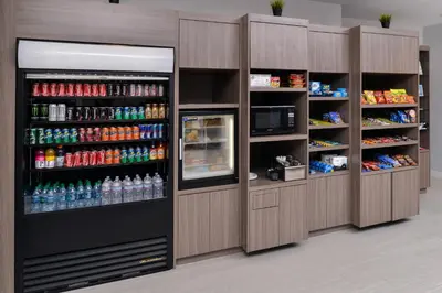 a drink station with a lot of soda bottles at Holiday Inn Express & Suites San Diego - Mission Valley by IHG in San Diego