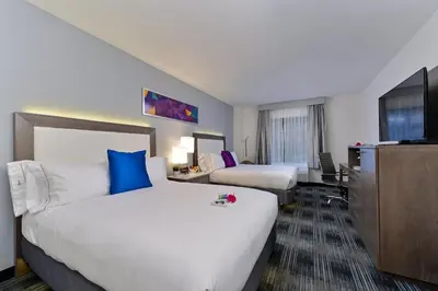 a hotel room with two beds and a flat screen tv at Holiday Inn Express & Suites San Diego - Mission Valley by IHG in San Diego