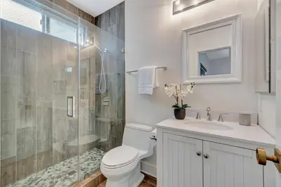 a bathroom with a toilet and a shower and a sink at Steps to Lido Village and the Marina Heart of Lido Island WITH PARKING in Newport Beach