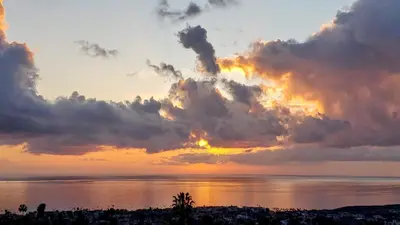 a sunset over the water with clouds at Ocean Views Beach House - 40 PCT Off Monthly in San Clemente