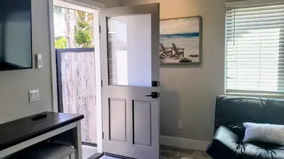 a living room with a white door and a couch at Ocean Views Beach House - 40 PCT Off Monthly in San Clemente