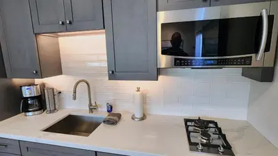 a kitchen counter with a sink and a microwave at Ocean Views Beach House - 40 PCT Off Monthly in San Clemente