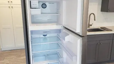 an empty refrigerator with its door open in a kitchen at Ocean Views Beach House - 40 PCT Off Monthly in San Clemente