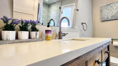 a bathroom with a sink and a bottle of wine at Ocean Views Beach House - 40 PCT Off Monthly in San Clemente