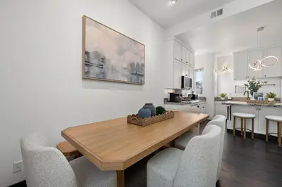 a kitchen and dining room with a wooden table and chairs at City Lights and Rooftop Nights by Rather Be Properties in San Diego