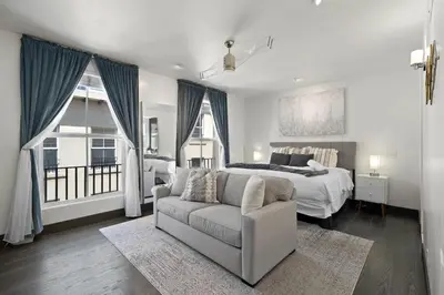 a bedroom with a bed and a couch and a bed at City Lights and Rooftop Nights by Rather Be Properties in San Diego