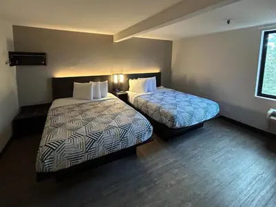 a hotel room with two beds and a window at Studio 6 San Diego, CA Hotel Circle Mission Valley in San Diego