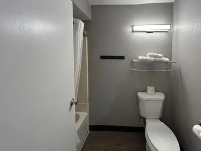 a bathroom with a white toilet and a shower at Studio 6 San Diego, CA Hotel Circle Mission Valley in San Diego