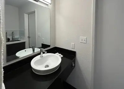 a bathroom with a sink and a mirror at Studio 6 San Diego, CA Hotel Circle Mission Valley in San Diego