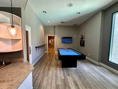 a room with a pool table in a house at Allura Little Italy - 2 BR in Downtown's Top Spot in San Diego