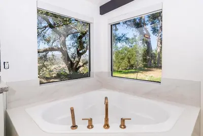a white sink in a bathroom with two windows at Casa Via Zara - Sweeping Mountain Views with Pool in Fallbrook
