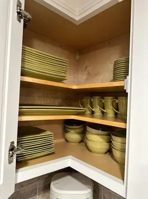 a cabinet filled with plates and bowls in a kitchen at Anselmo in Mission Viejo