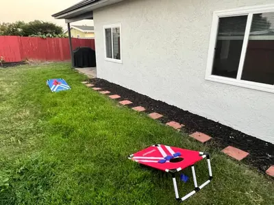 a umbrella sitting on the grass next to a house at NEW CA Coastal Beauty 6 mins to Imperial Beach in San Diego
