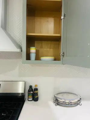 a kitchen counter top with a cupboard and a stove at NEW CA Coastal Beauty 6 mins to Imperial Beach in San Diego