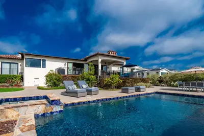 a home with a swimming pool and a house at Spanish Dream with Ocean Views in Encinitas