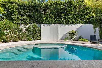 a swimming pool with blue water in a yard at Sea Serenity Coastline Views and Pool in San Diego
