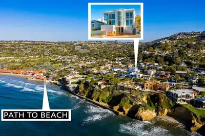 a view of a beach with a sailboat in the water at Sea Serenity Coastline Views and Pool in San Diego