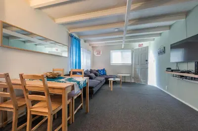 a dining room and living room with a table and a couch at Sandy Toes in San Diego