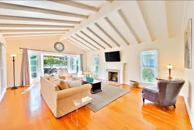a living room with a couch and a fireplace at Beach Happy in San Diego